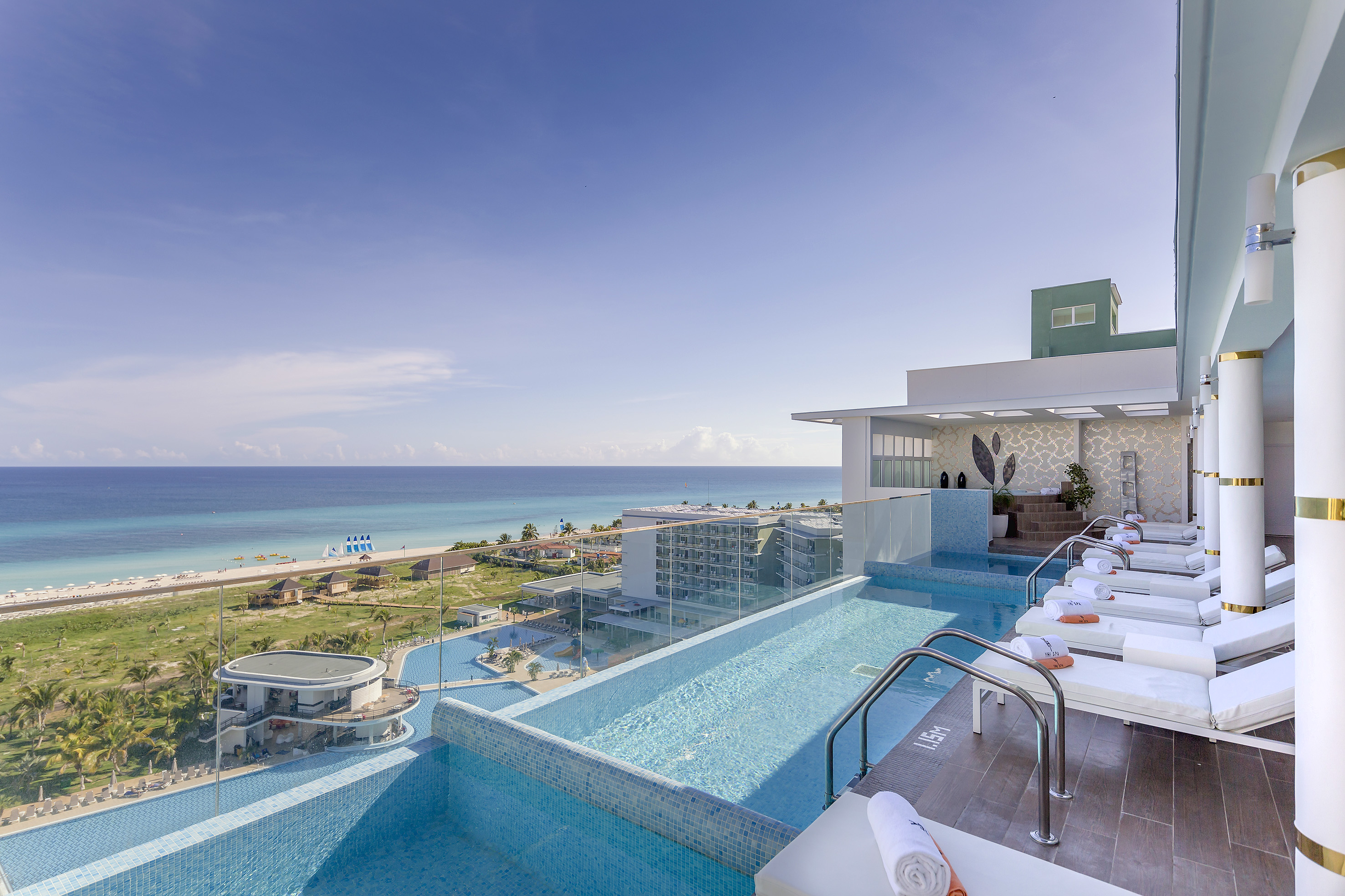 a pool with a deck and chairs on top of it