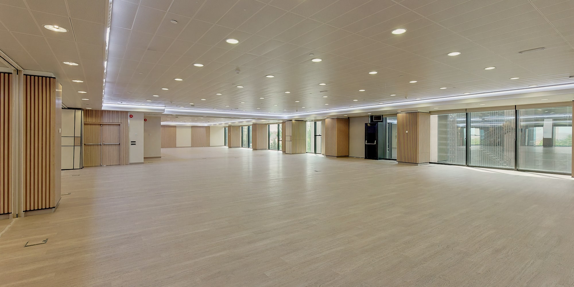 a large room with a wood floor and a white ceiling