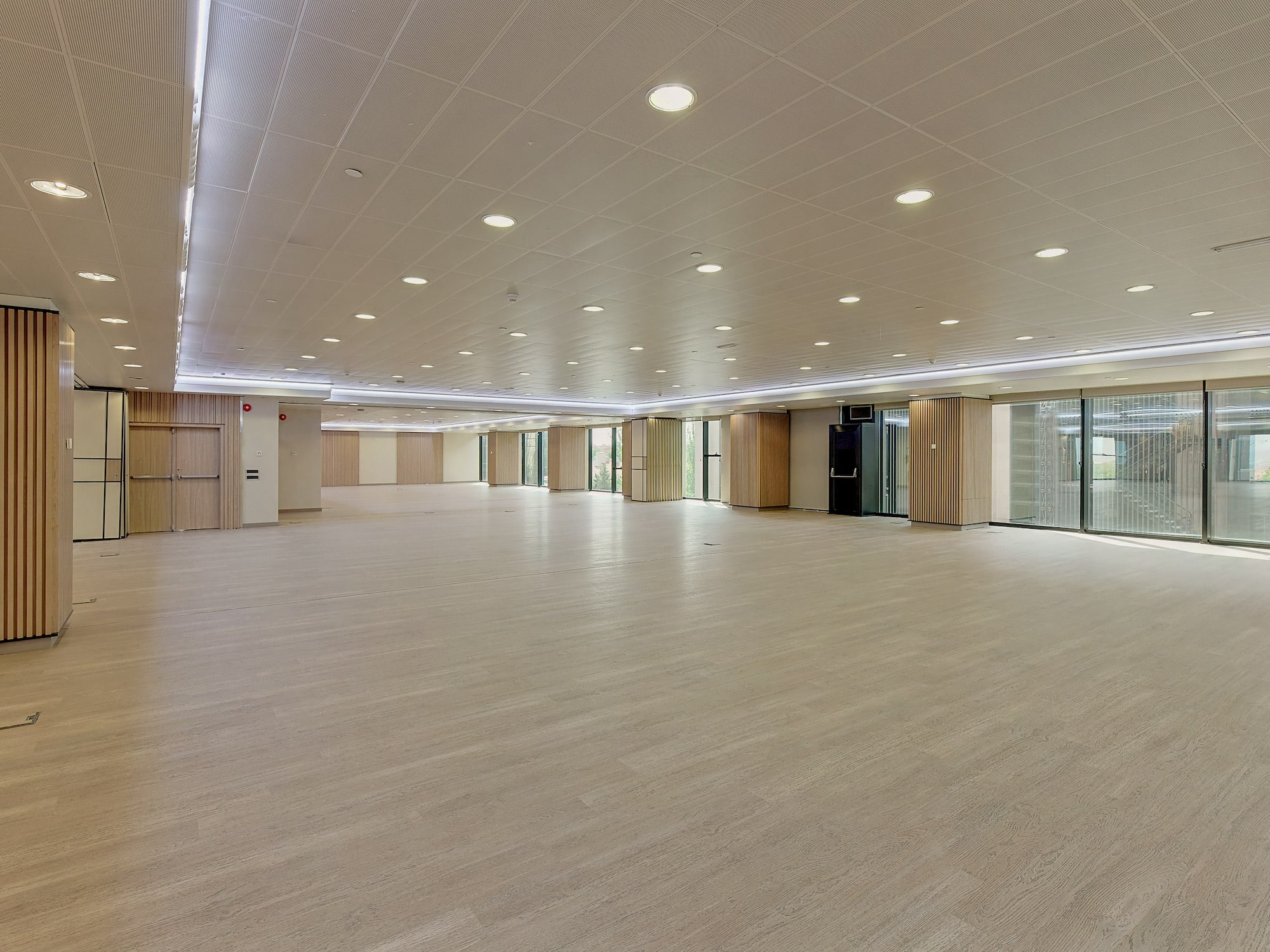 a large room with a wood floor and a white ceiling