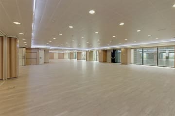 a large room with a wood floor and a white ceiling