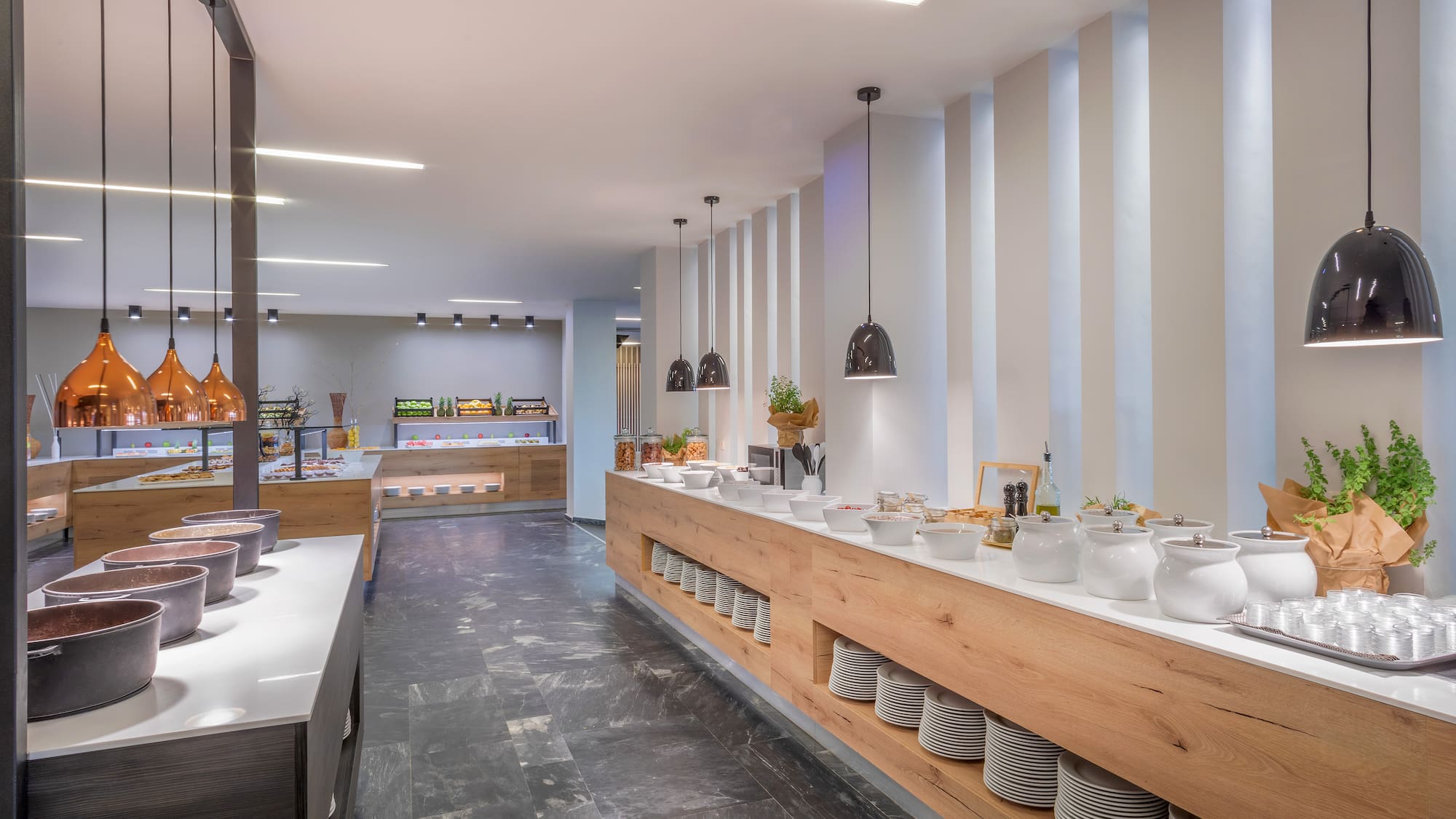 a buffet line with white dishes on the counter