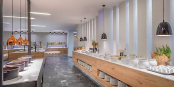 a buffet line with white dishes on the counter