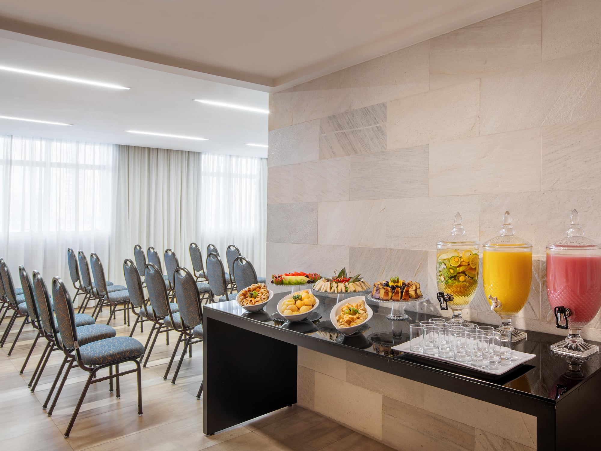 a table with food on it and a glass of juice in front of it