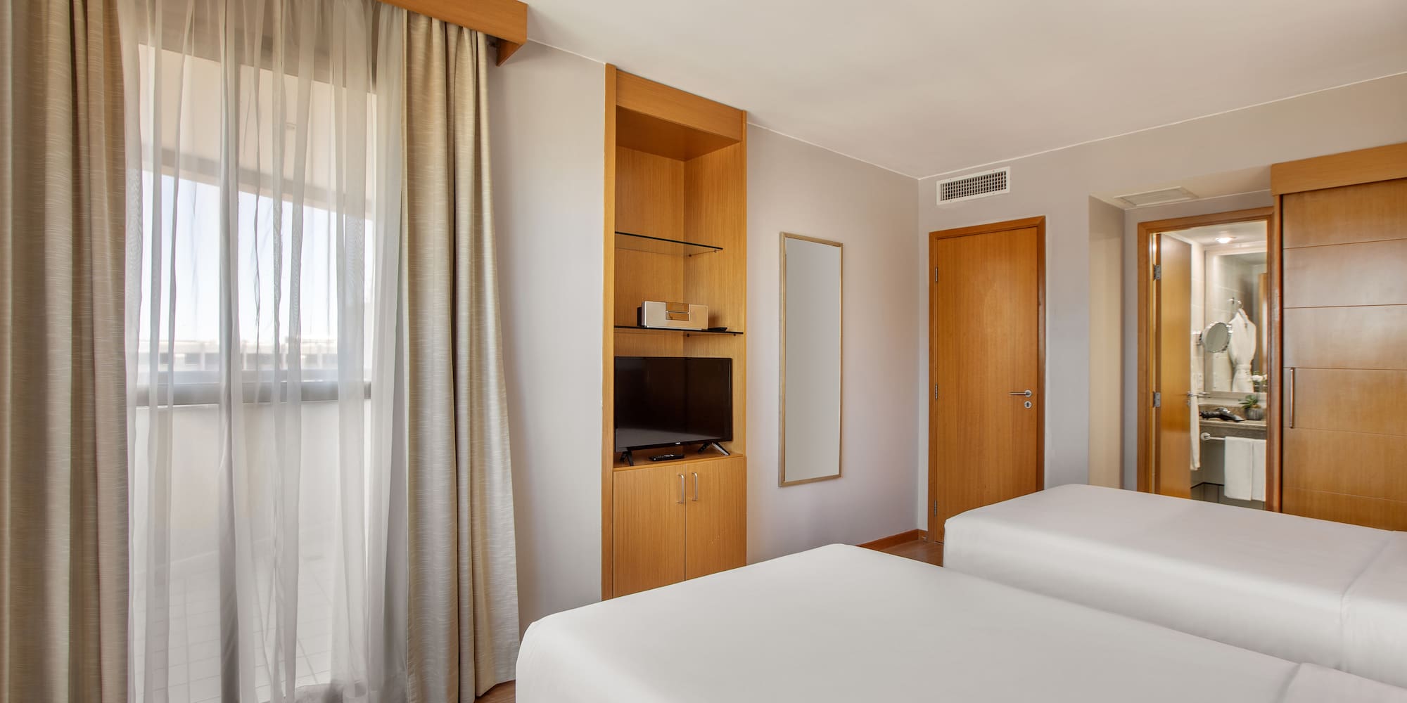 a room with two beds and a tv