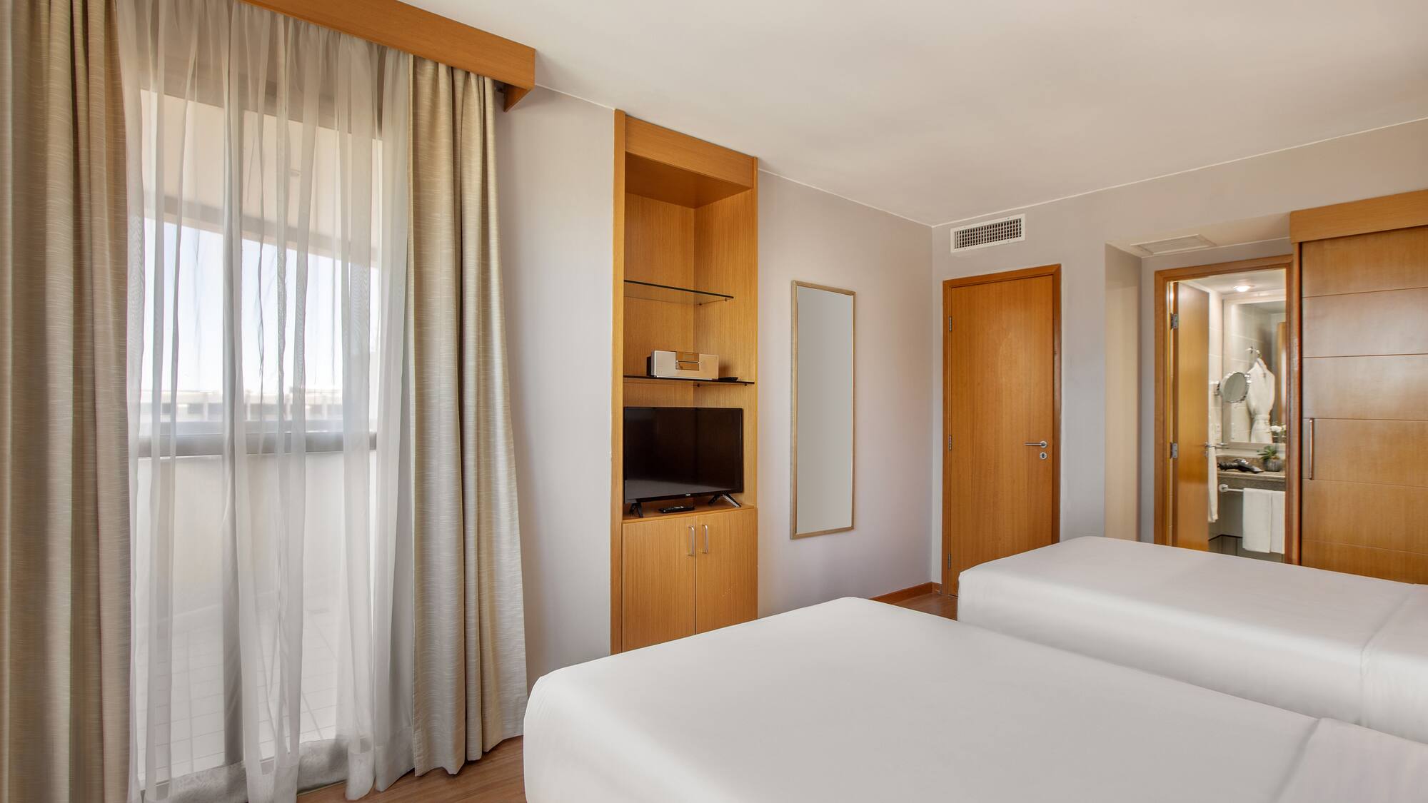 a room with two beds and a tv