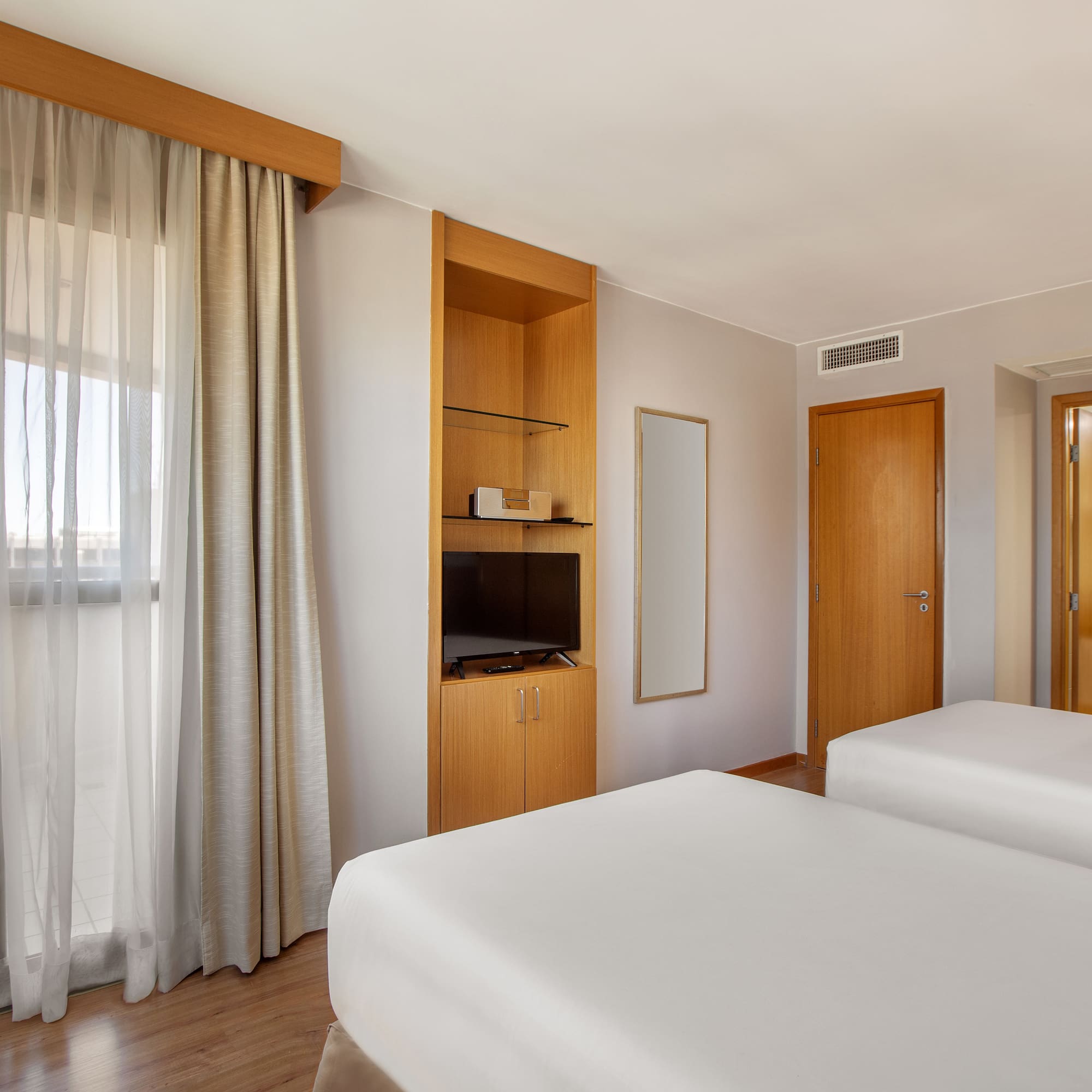 a room with two beds and a tv