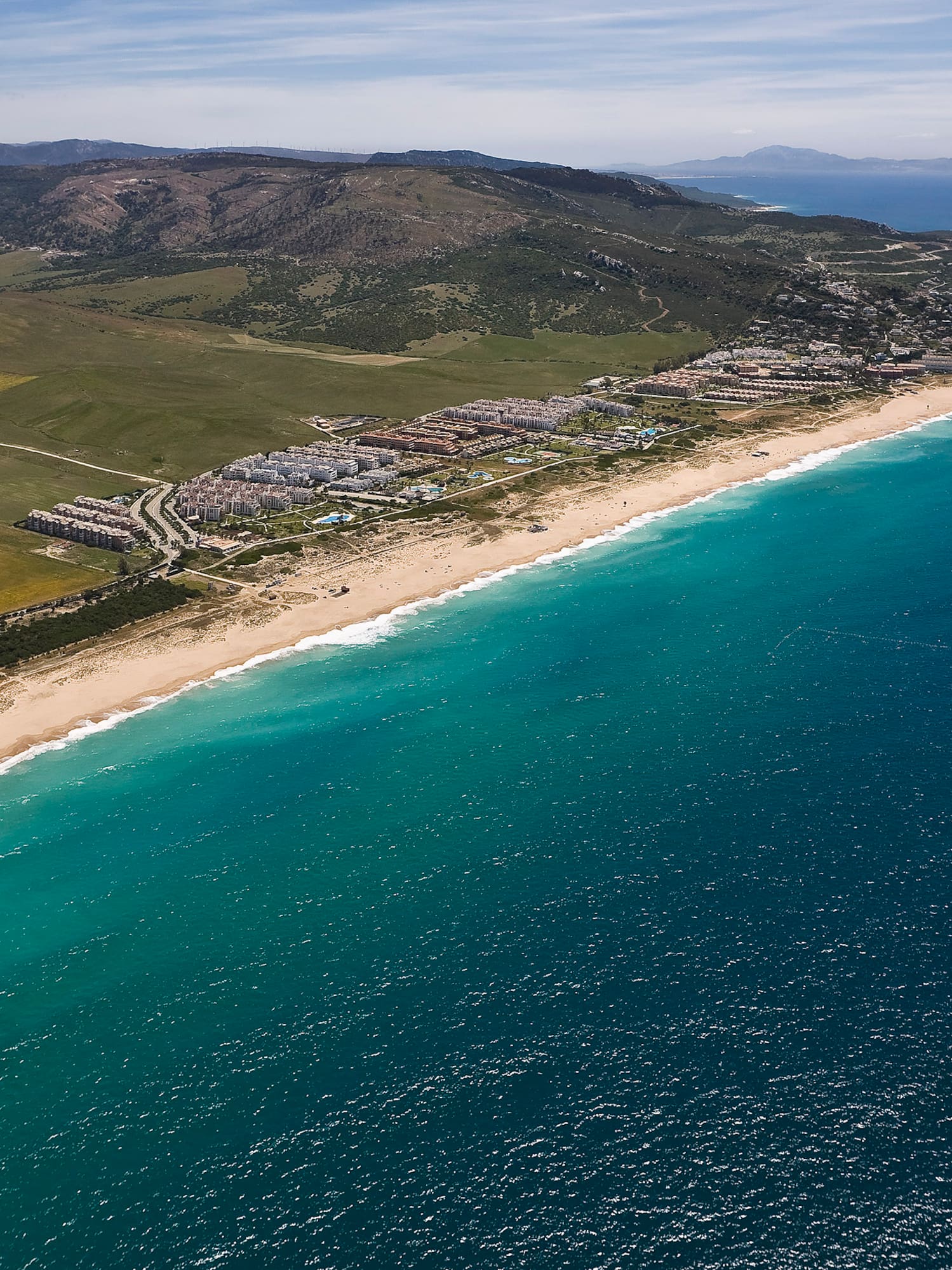 a beach with land and water