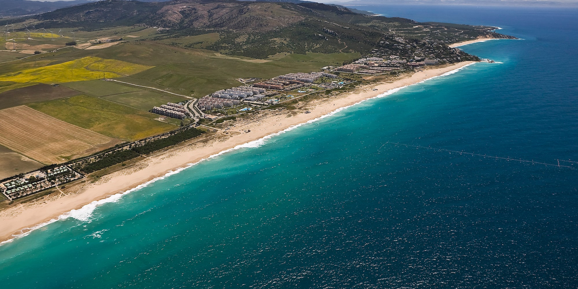 a beach with land and water