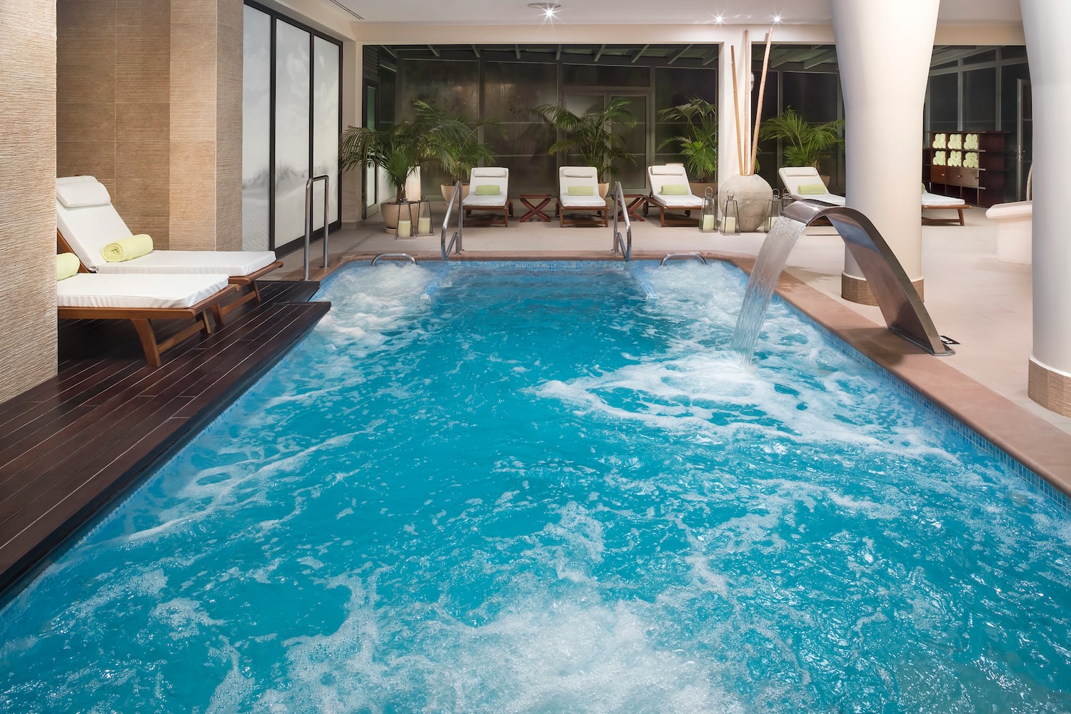 a swimming pool with a waterfall