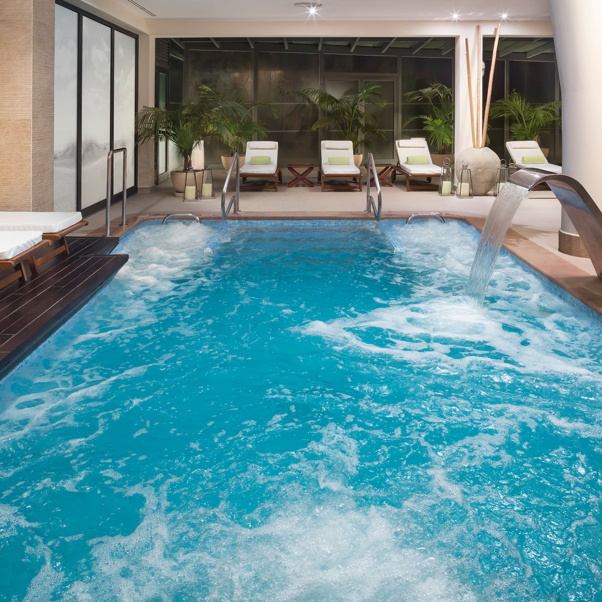 a swimming pool with a waterfall