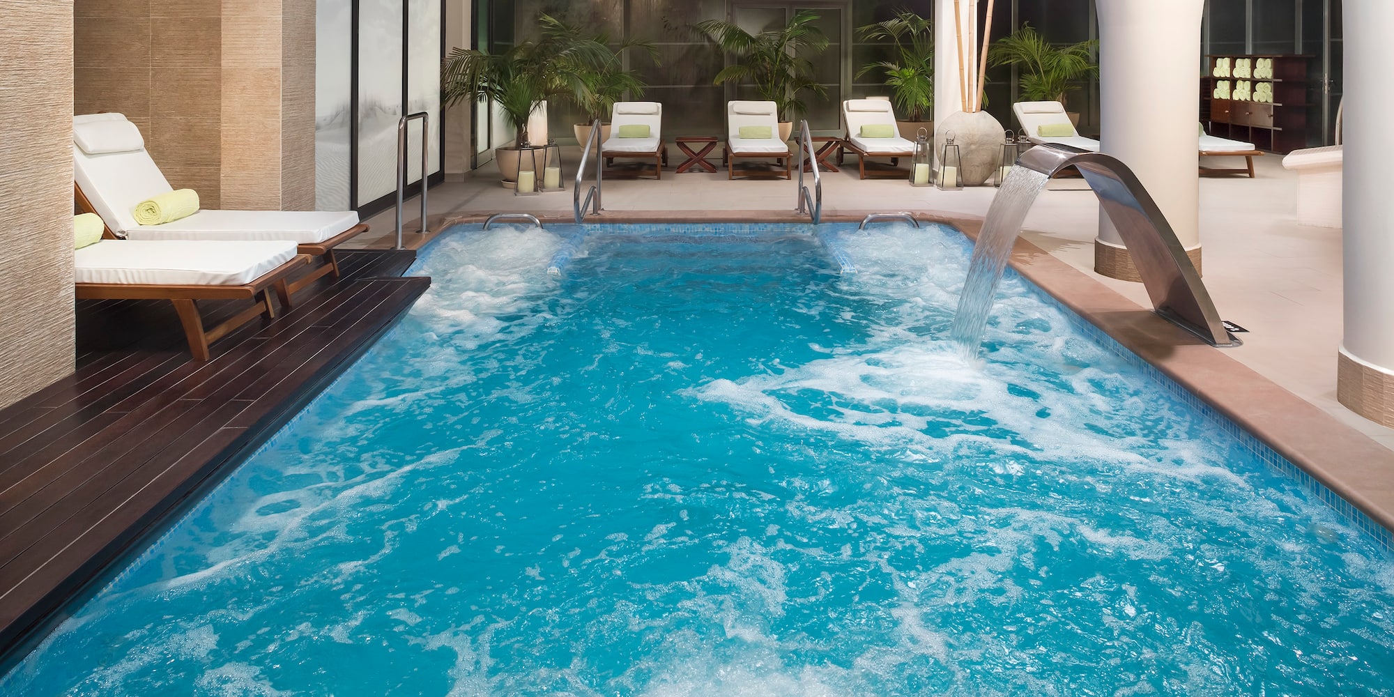 a swimming pool with a waterfall