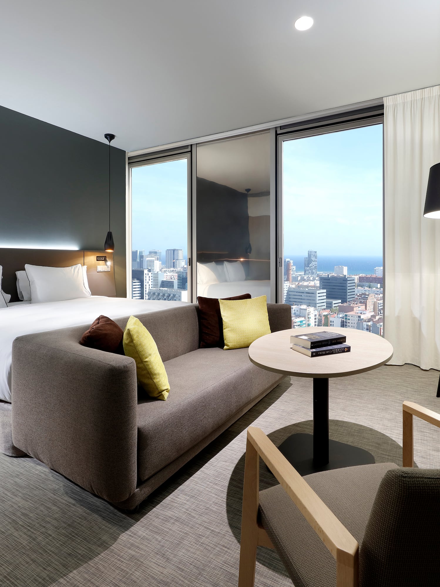 a room with a bed and a table and chairs