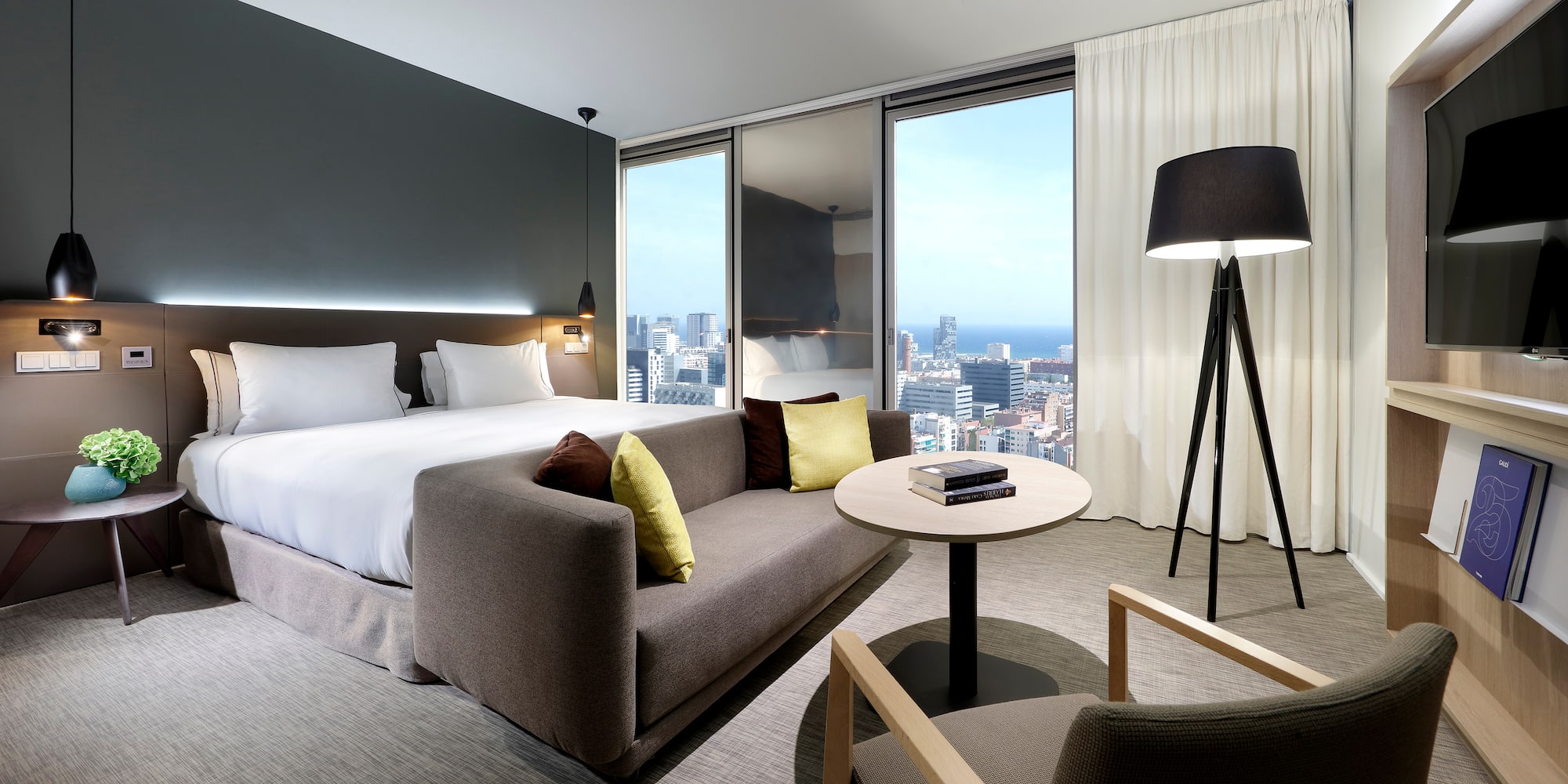 a room with a bed and a table and chairs