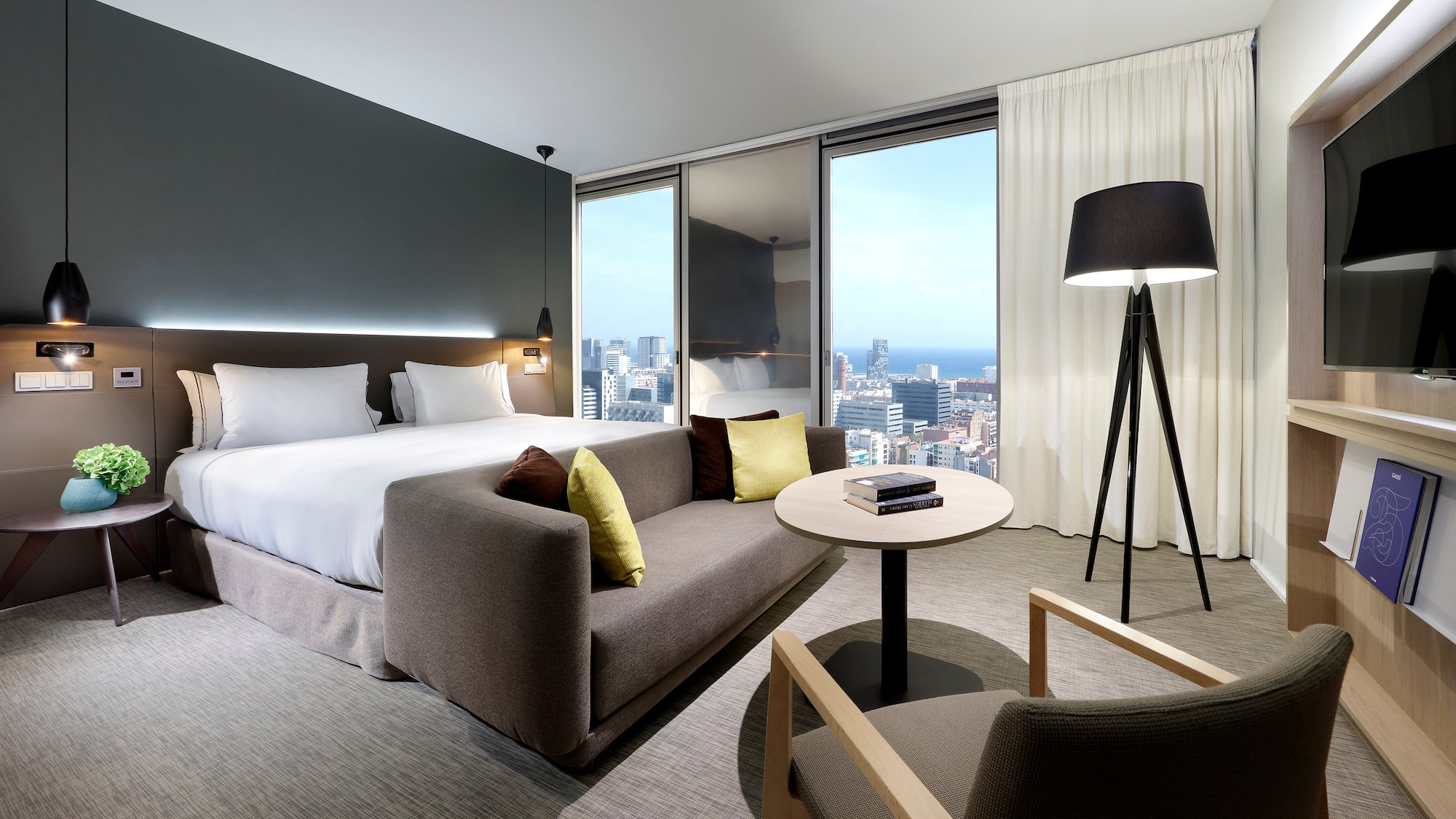 a room with a bed and a table and chairs