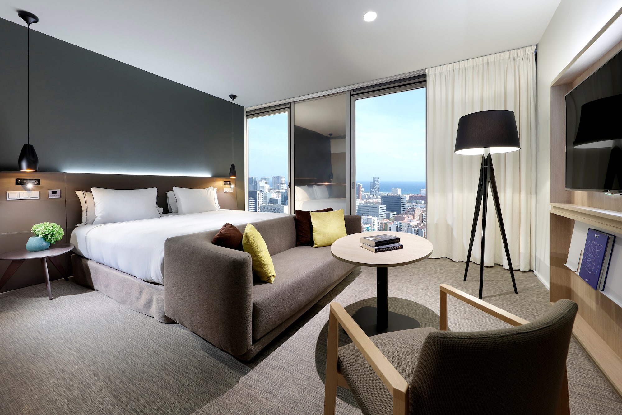 a room with a bed and a table and chairs