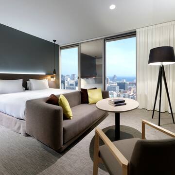 a room with a bed and a table and chairs