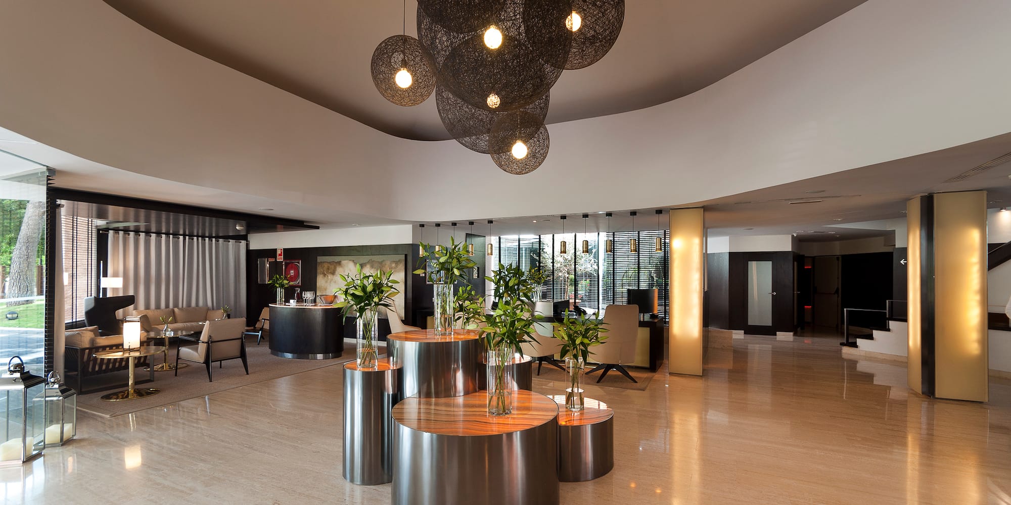a room with a large chandelier and tables with flowers
