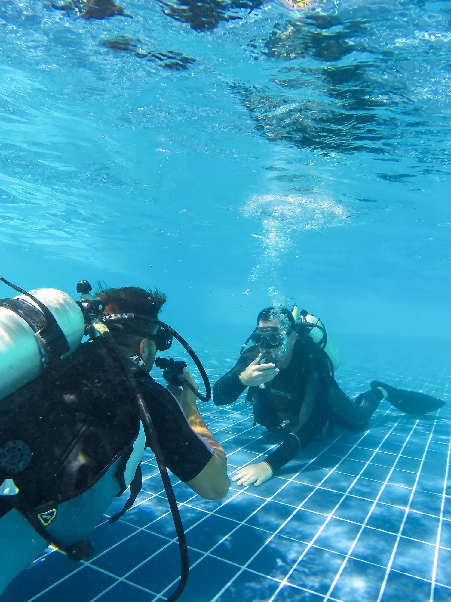 a group of people underwater in a pool
