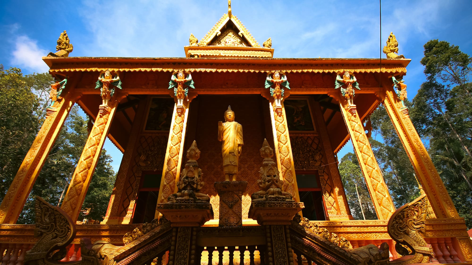 a gold building with a statue in the front