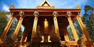a gold building with a statue in the front