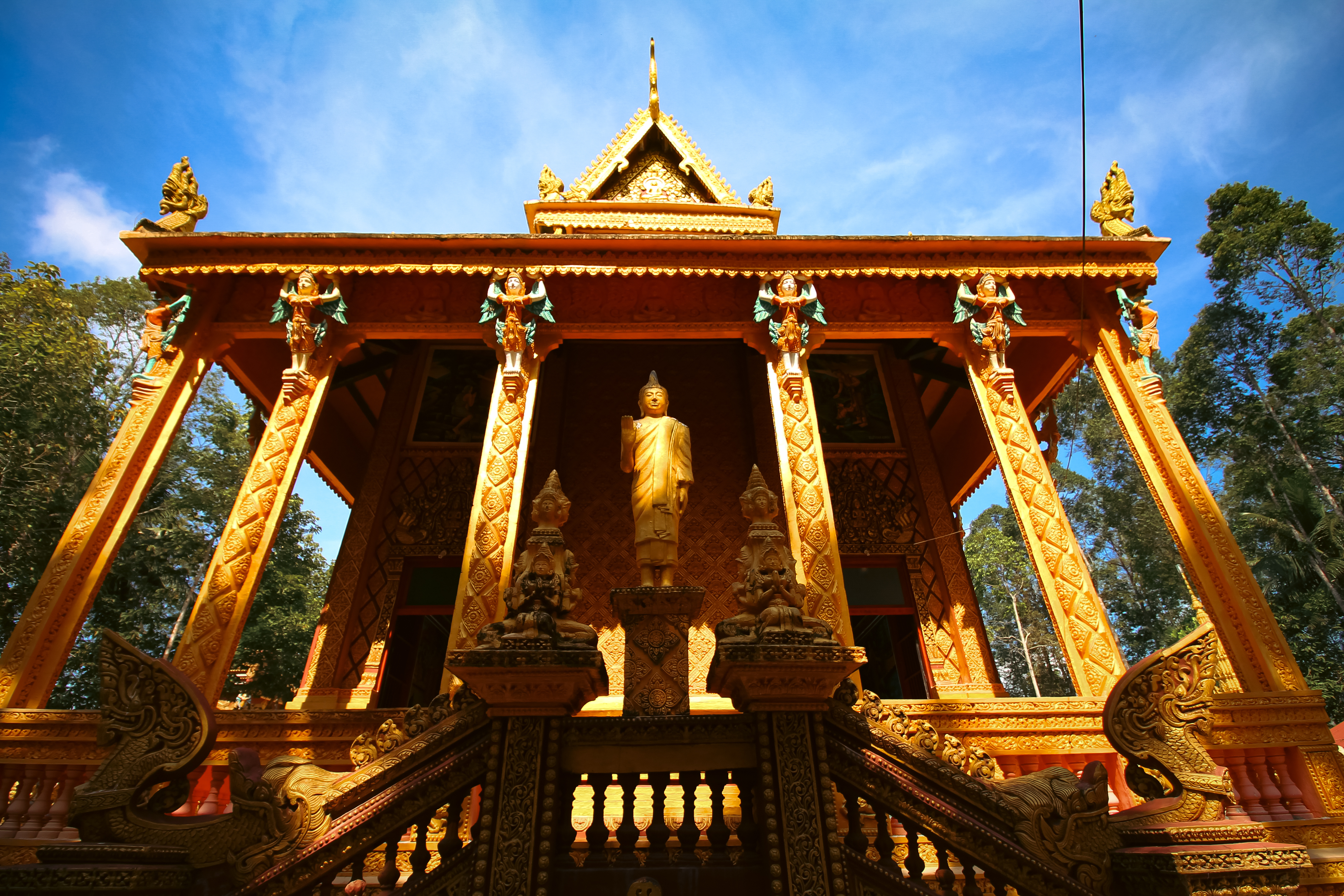 a gold building with a statue in the front