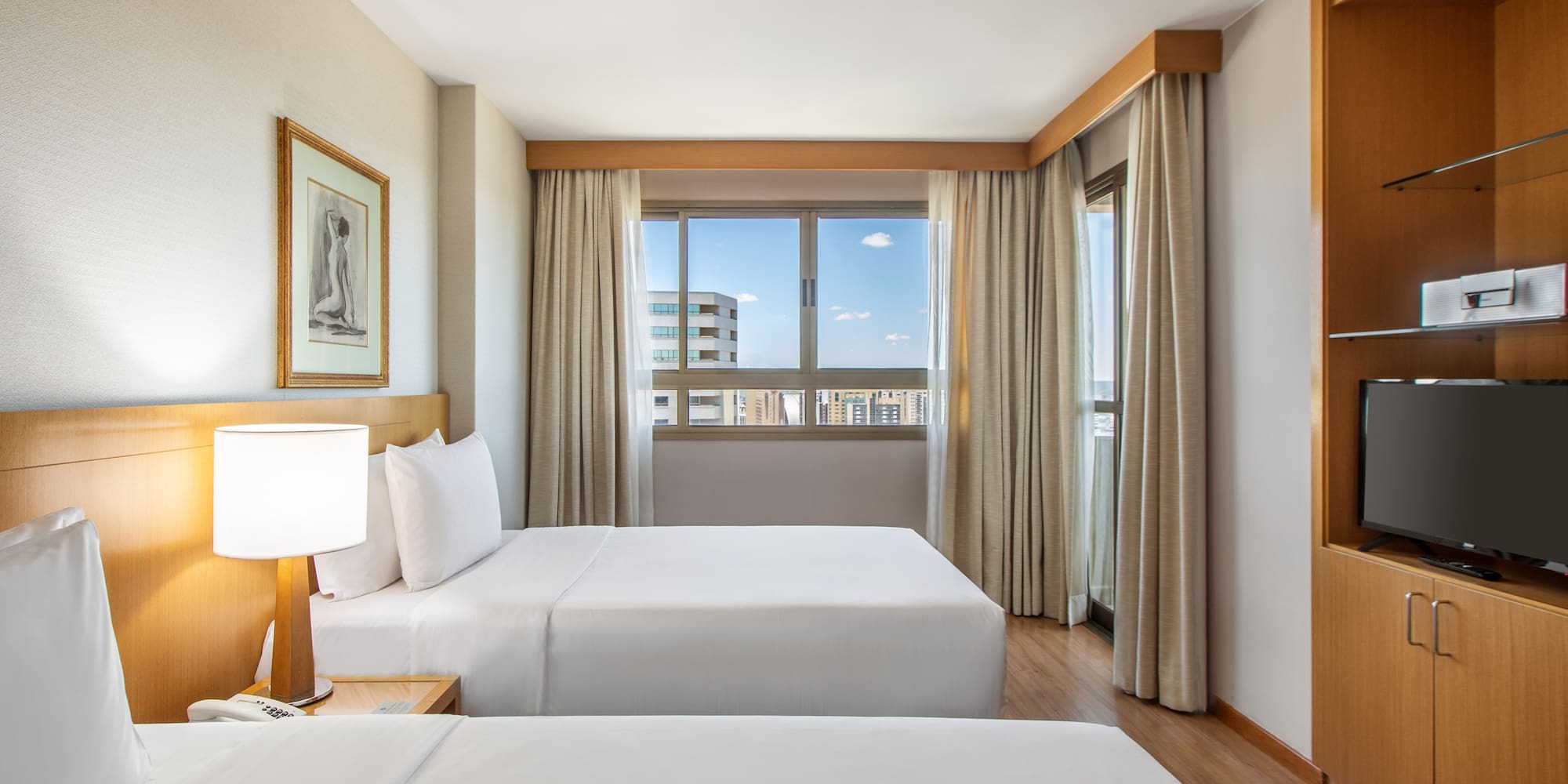 a room with two beds and a lamp