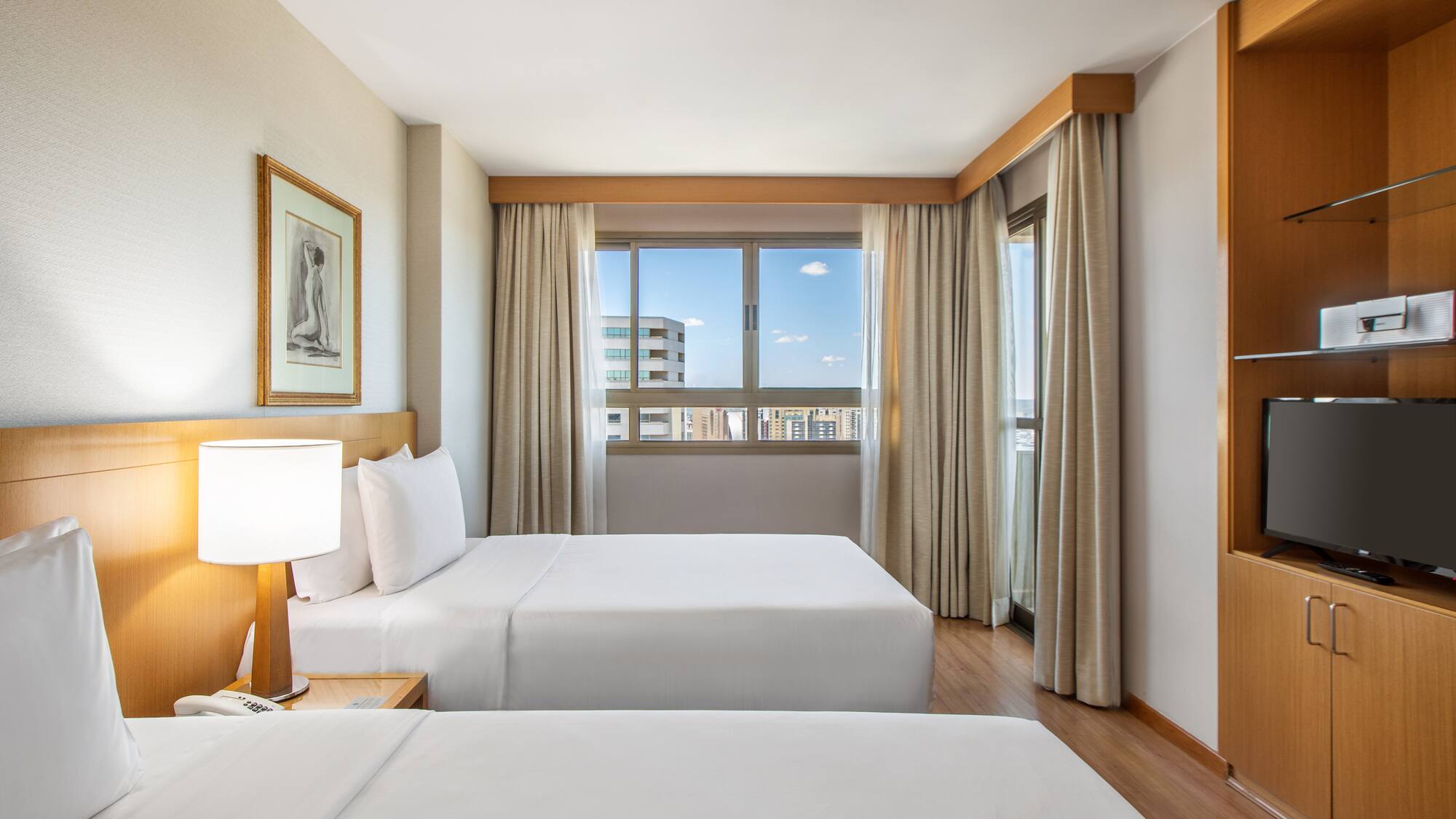 a room with two beds and a lamp