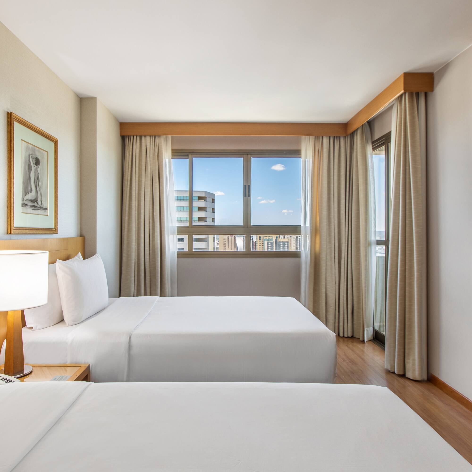 a room with two beds and a lamp