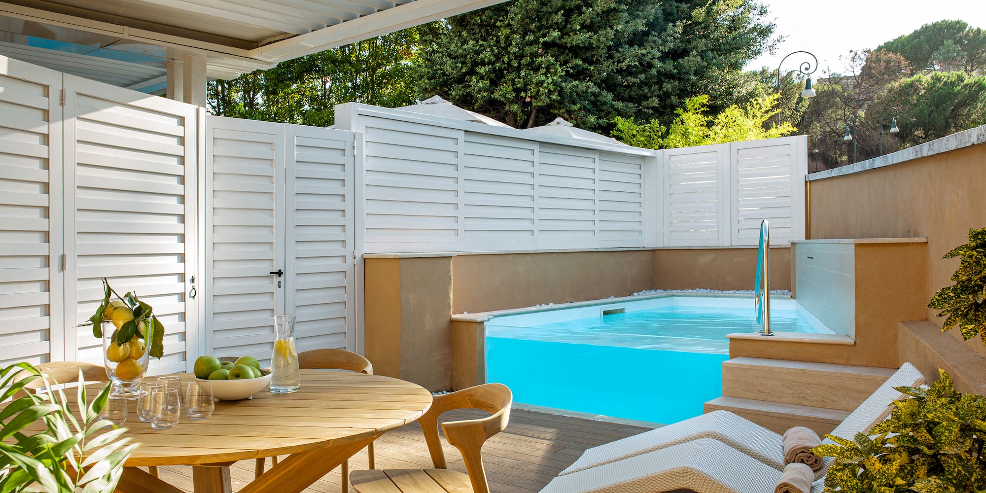 a patio with a pool and a table
