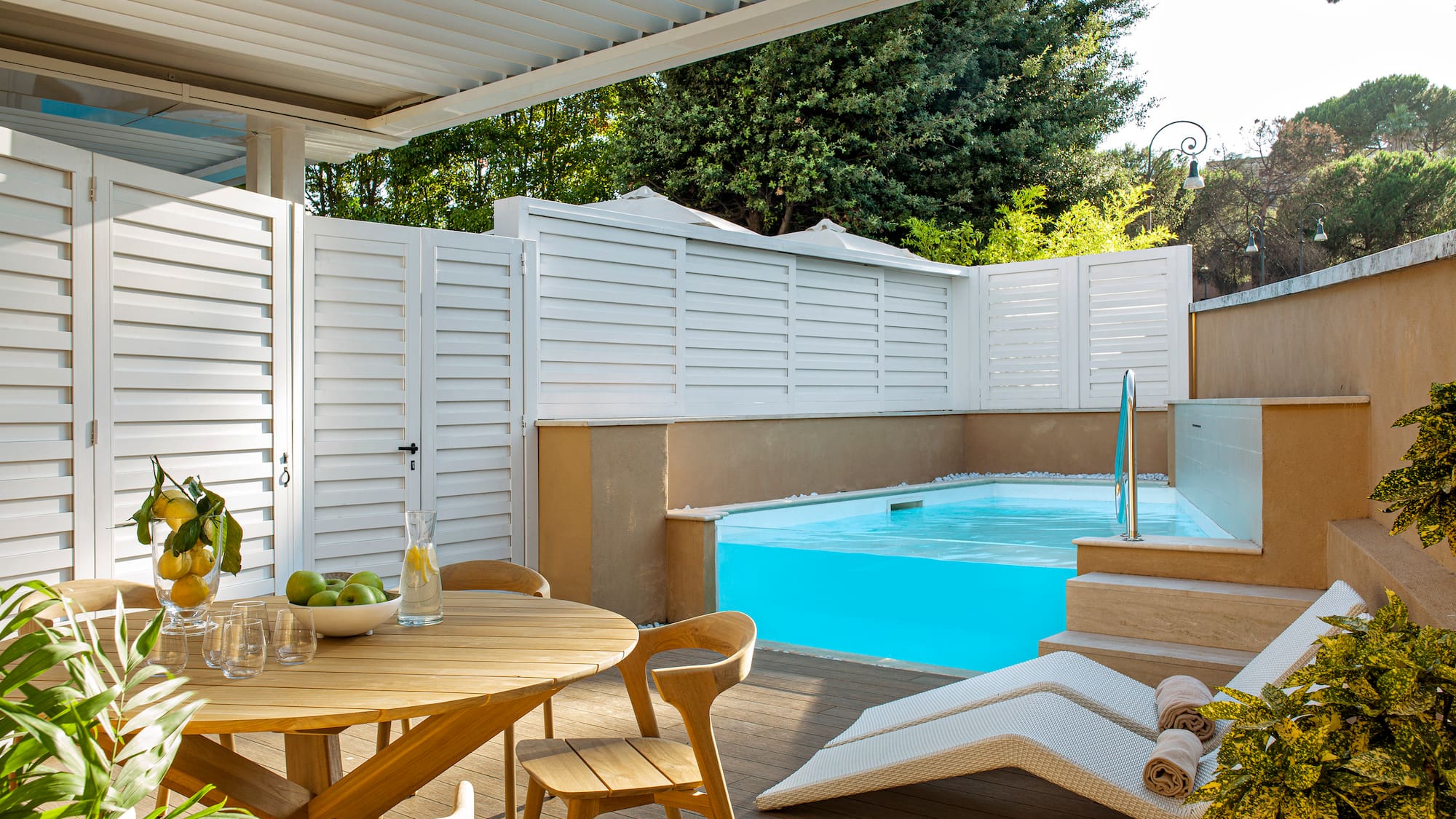 a patio with a pool and a table