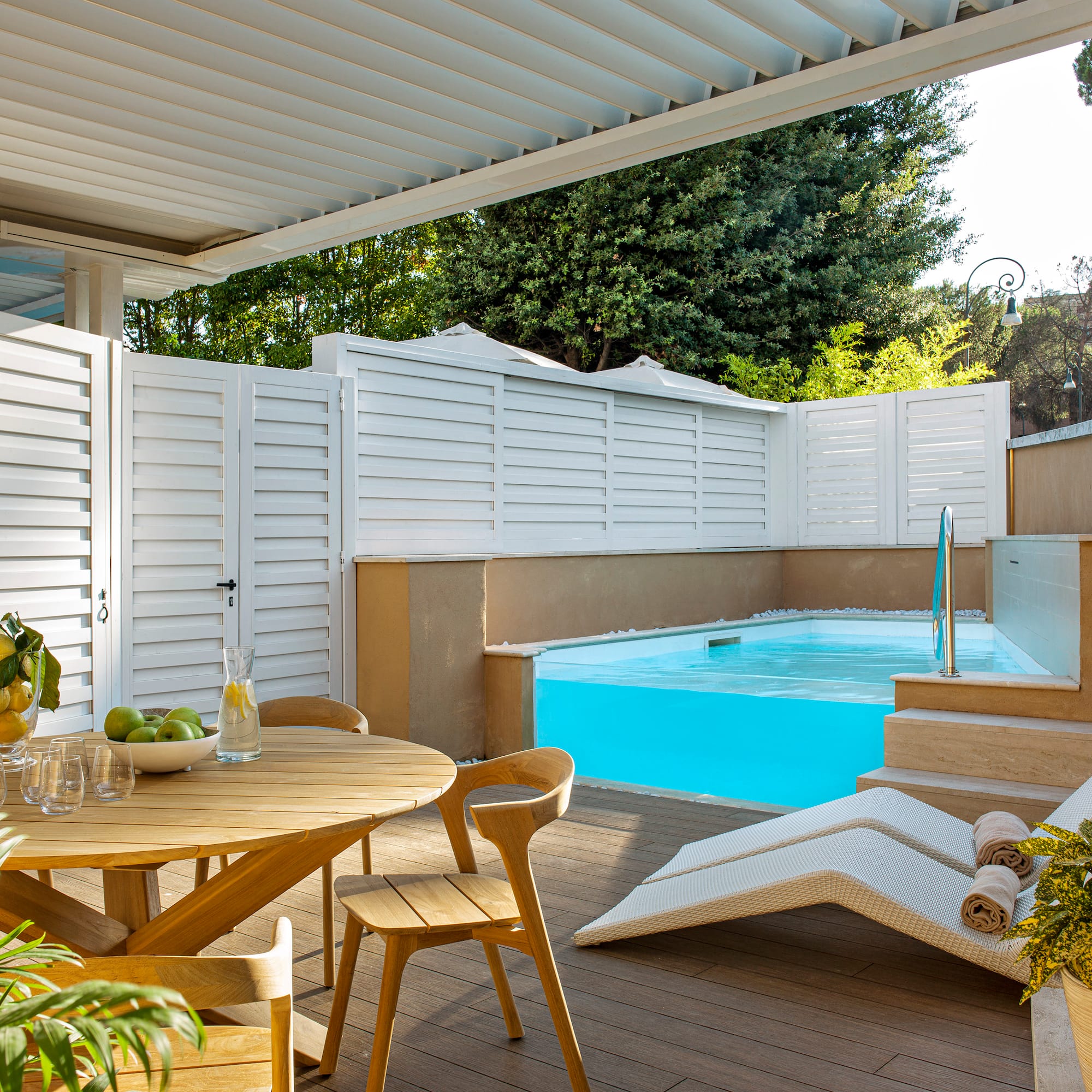 a patio with a pool and a table