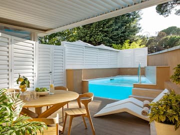a patio with a pool and a table