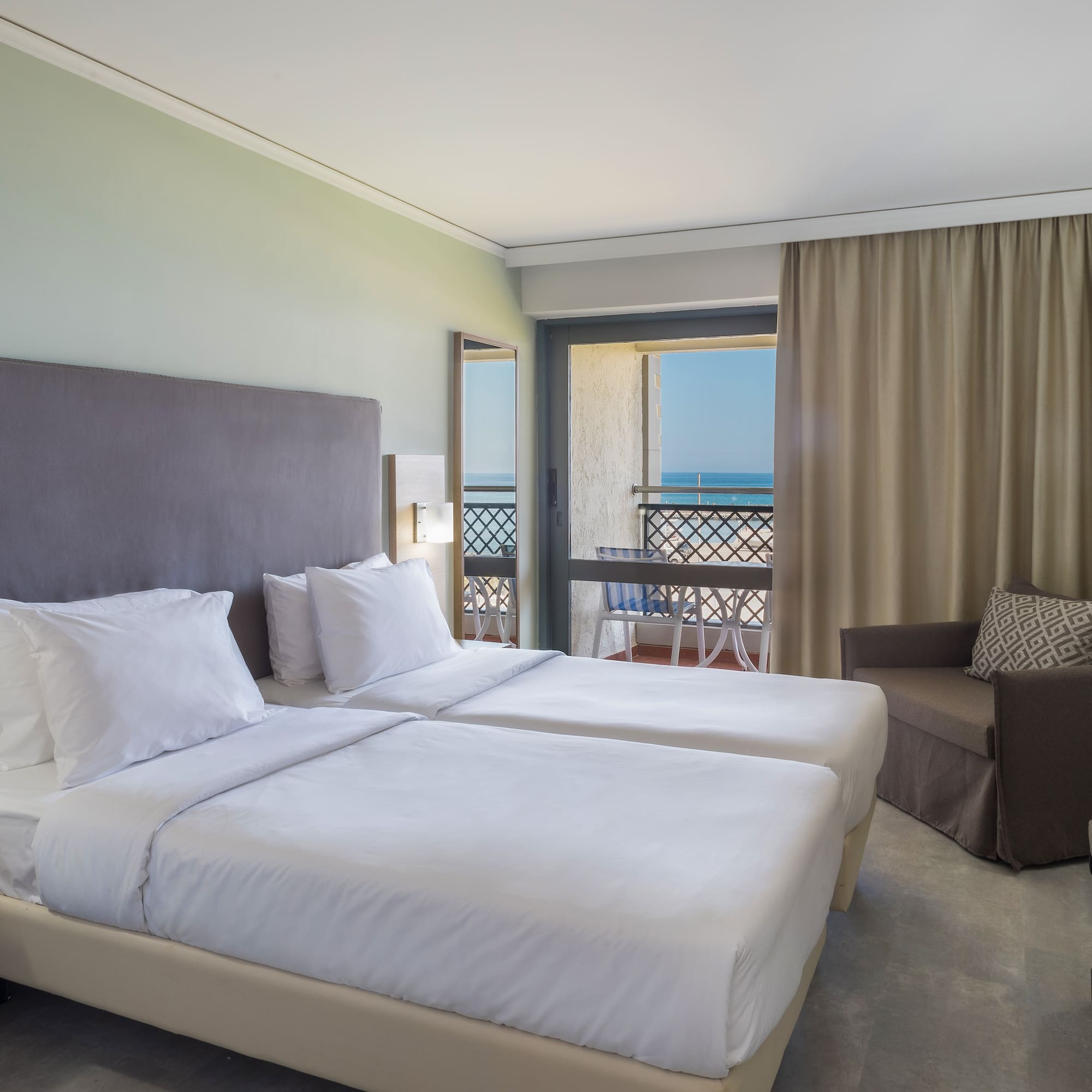 a room with two beds and a balcony