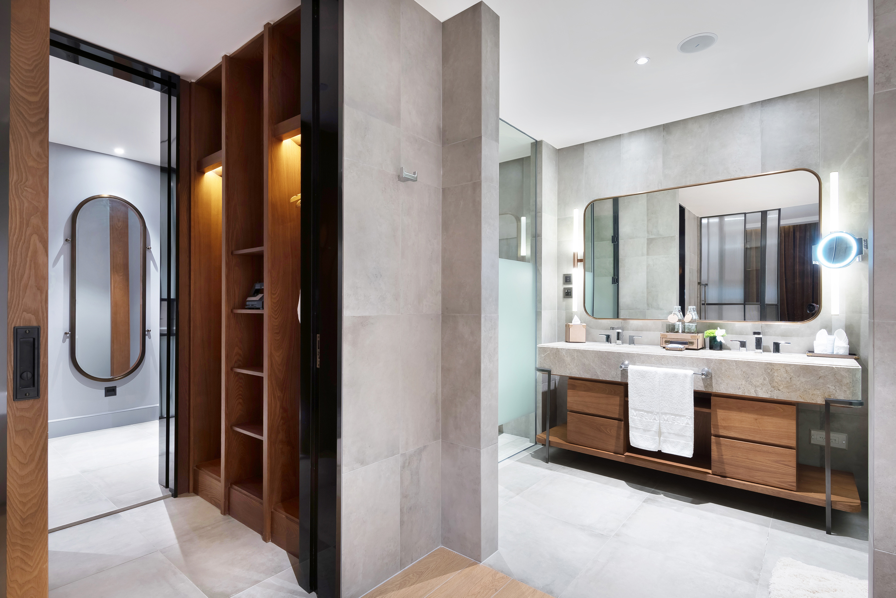 Stylish bathroom with double vanity, large mirror, and open wooden closet.