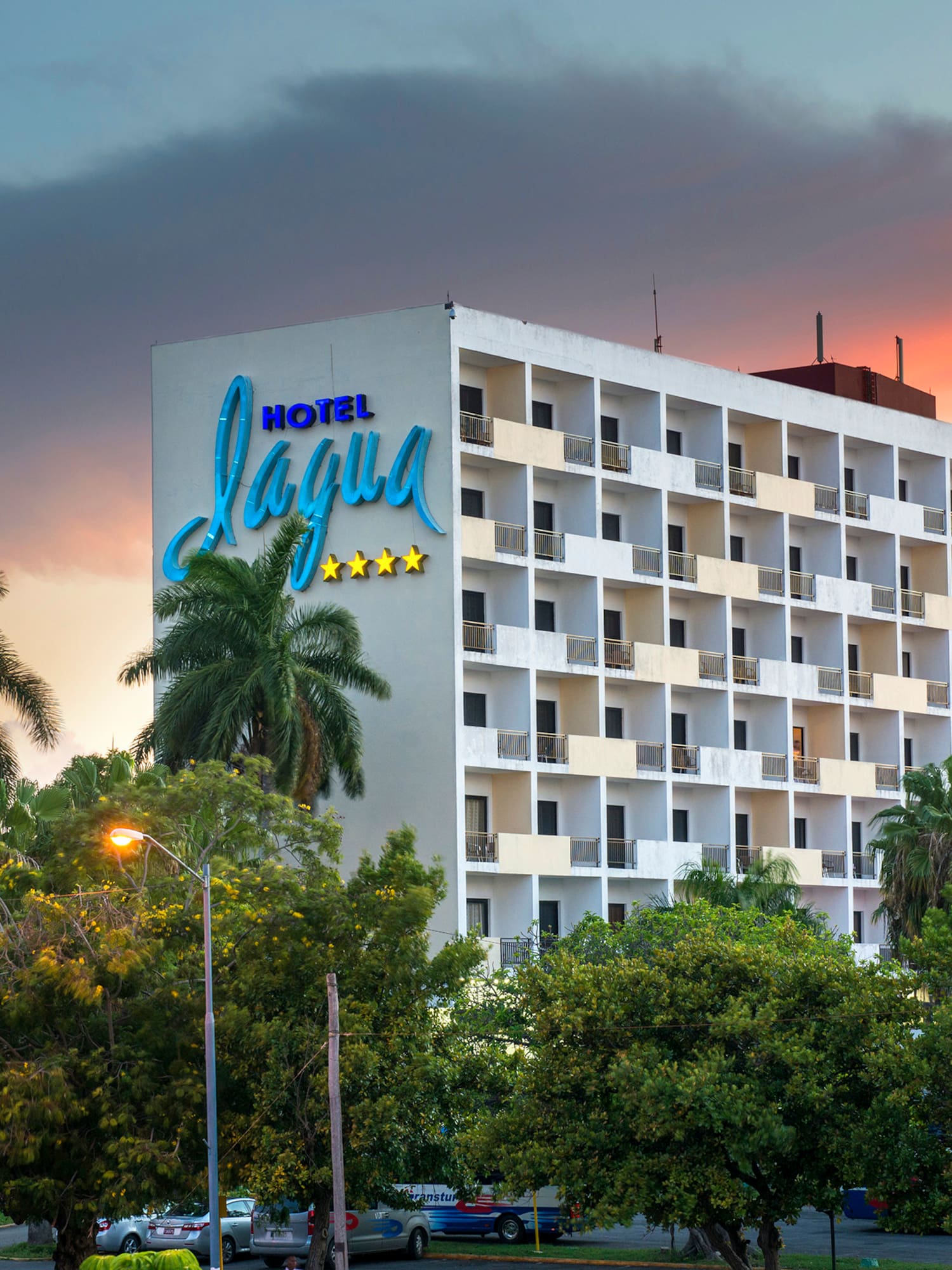 a building with trees and a sign