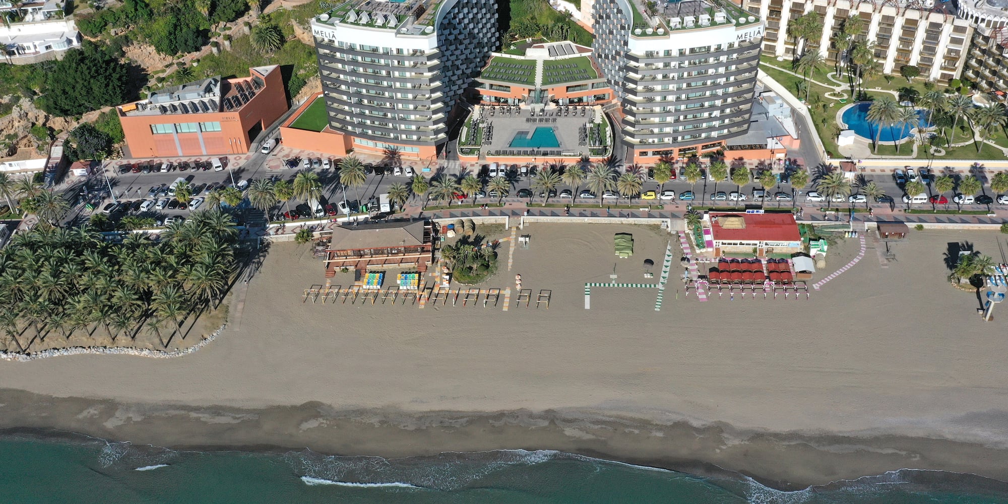 a beach with buildings and a body of water