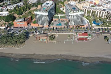 a beach with buildings and a body of water