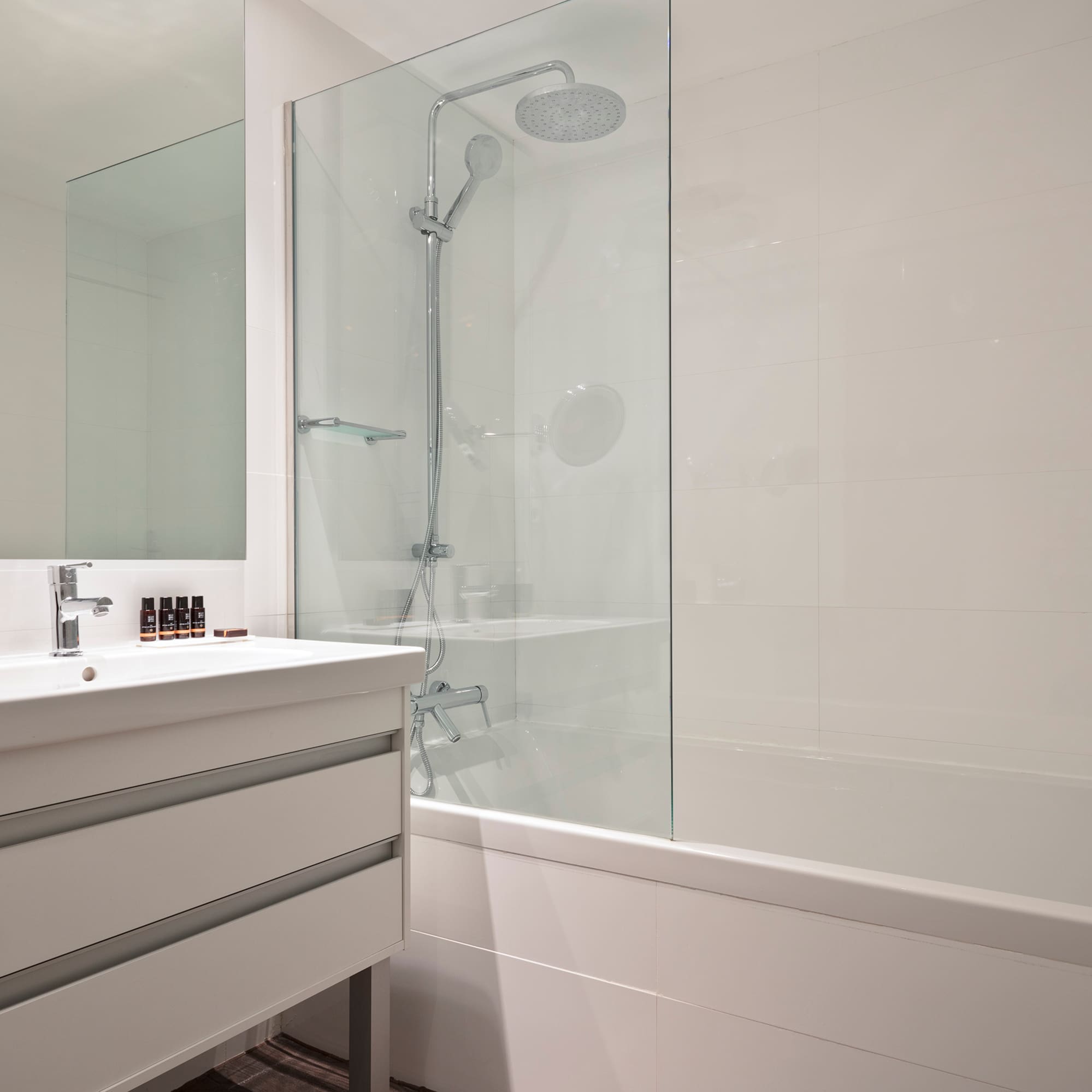 a bathroom with a shower and tub