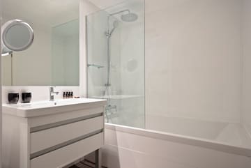 a bathroom with a shower and tub