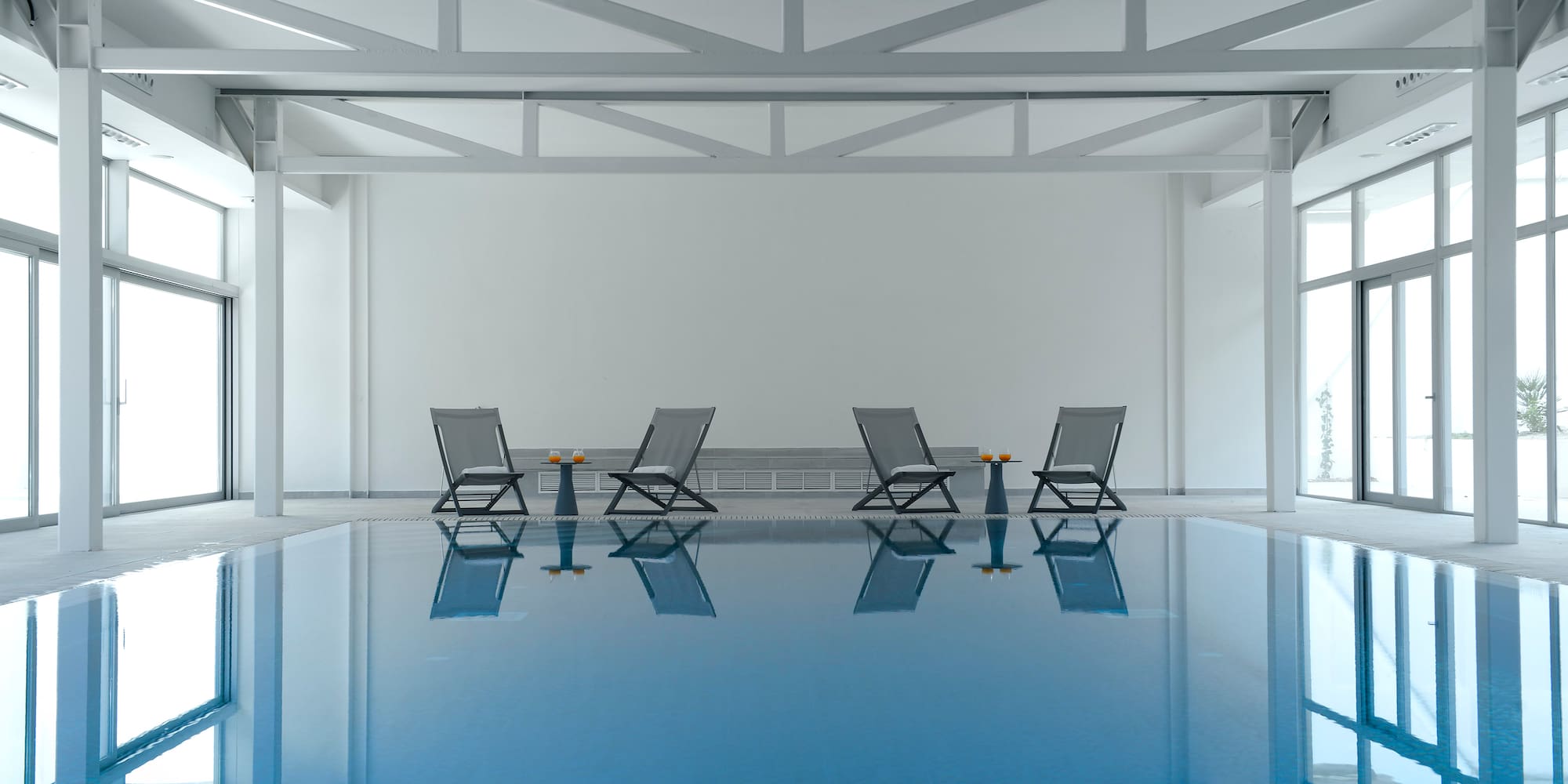 a pool with chairs and tables in it