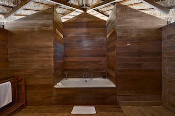 a bathtub in a wood room