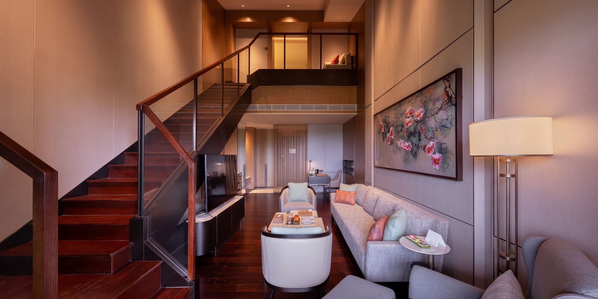 a living room with a staircase and a couch