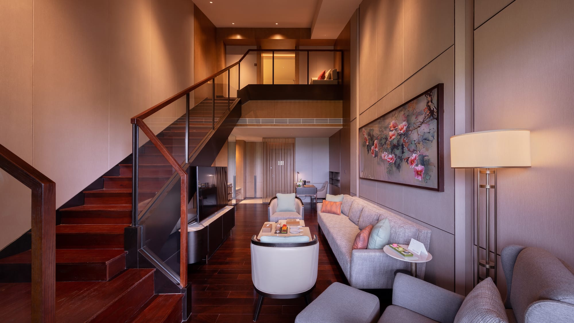 a living room with a staircase and a couch