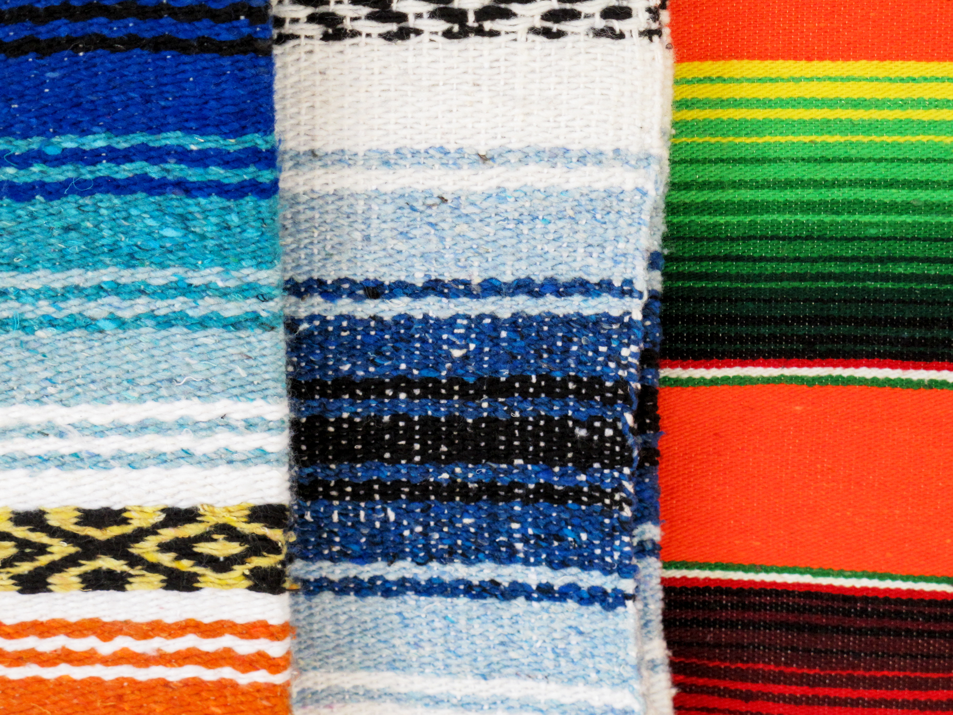 a group of colorful blankets
