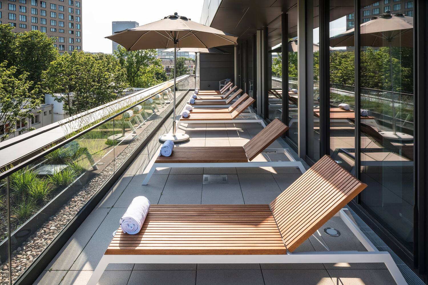 a row of lounge chairs on a balcony