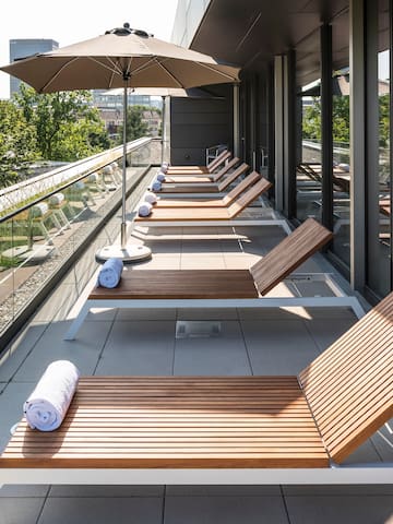 a row of lounge chairs on a balcony