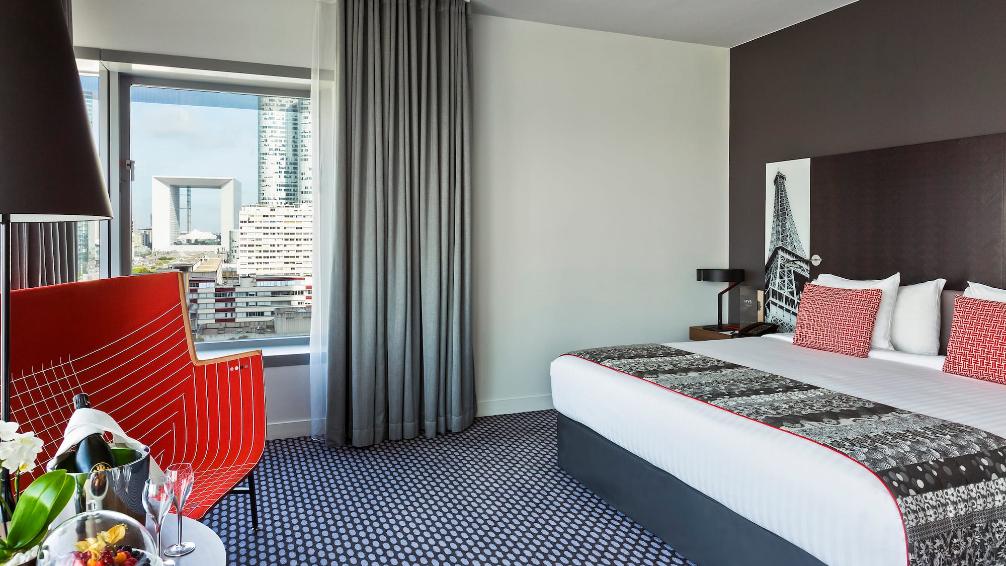 a room with a bed and a red chair