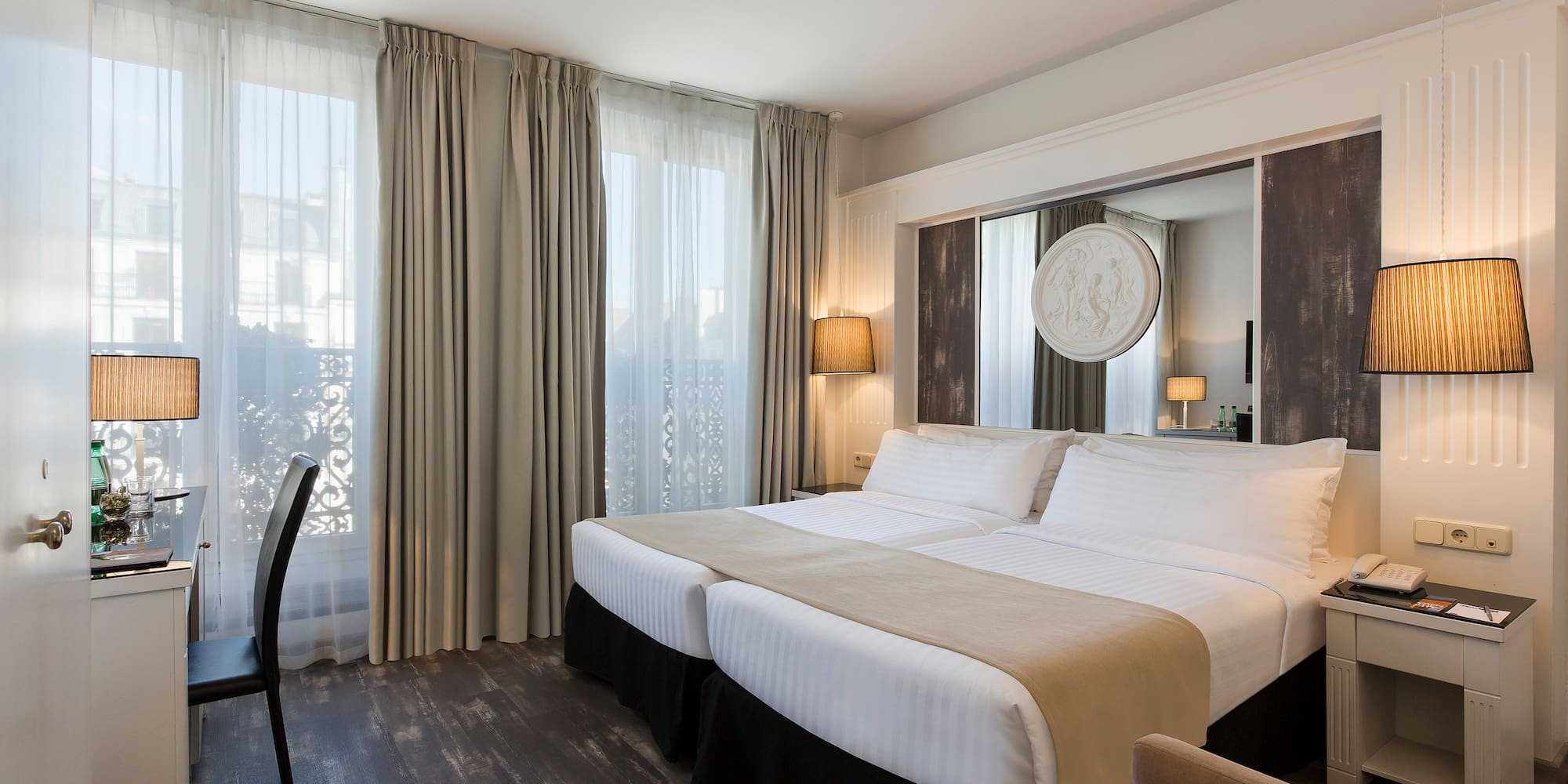 a room with two beds and a chair