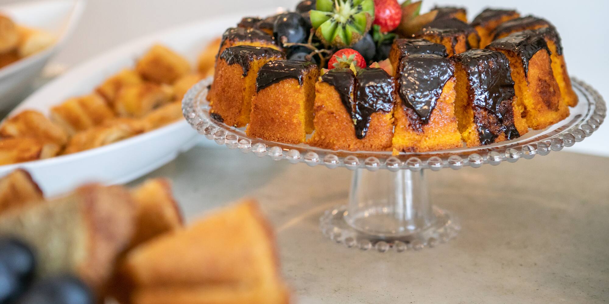 a cake with chocolate frosting and fruit on a plate