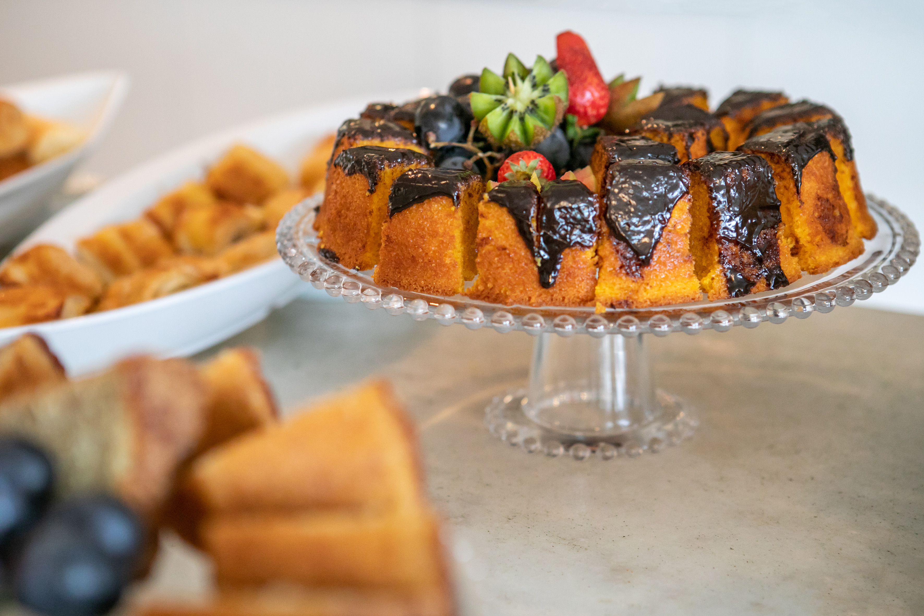 a cake with chocolate frosting and fruit on a plate